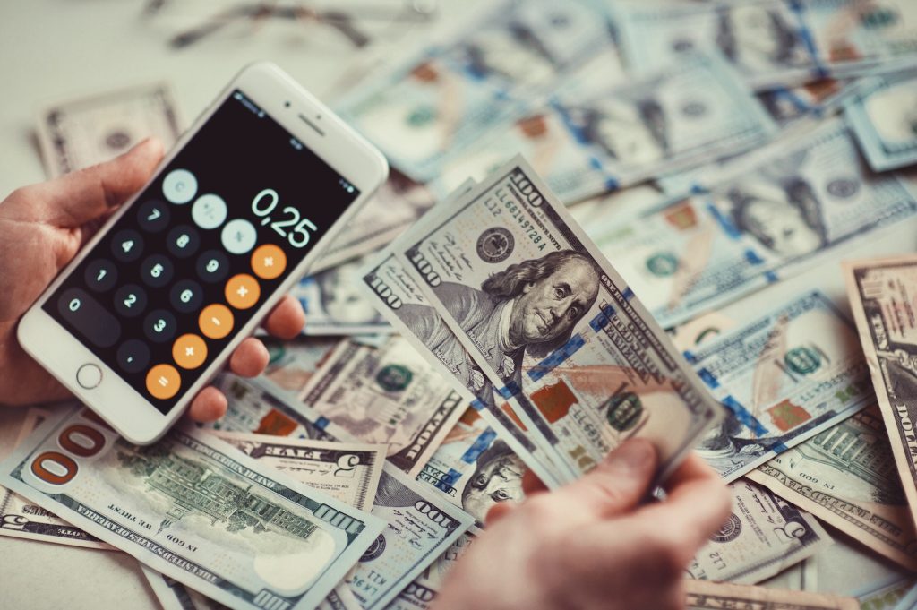 An image of cash and a calculator. Calculate how much you would save with a credit card consolidation loan.